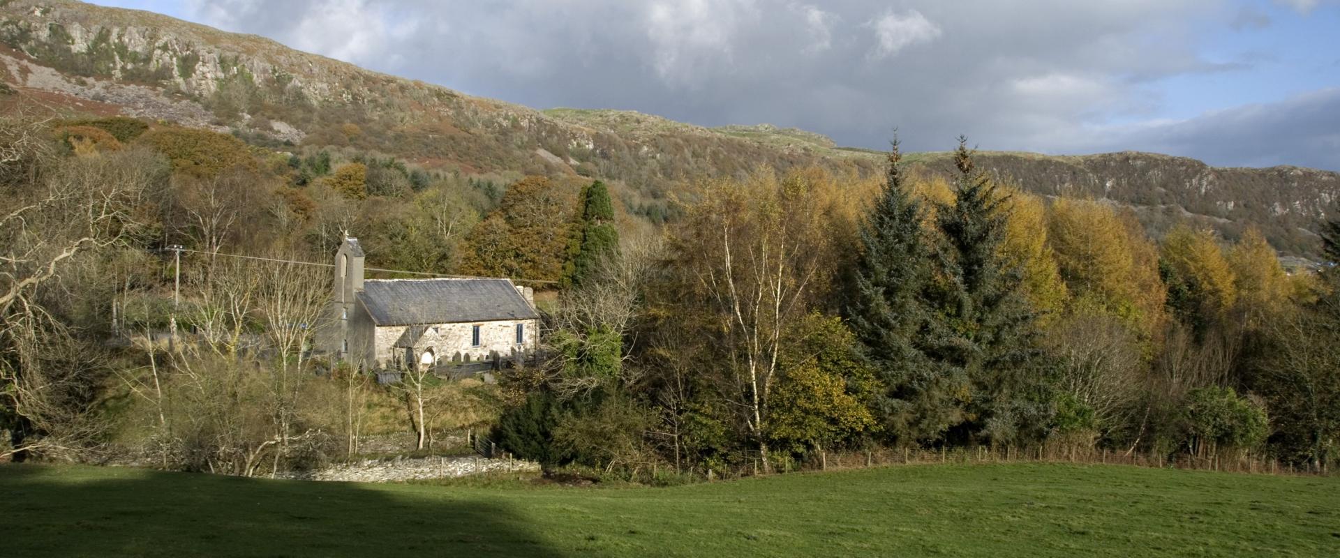outside shot across a field of St Beuno's, Penmorfa