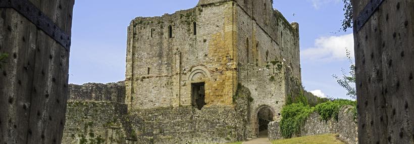Looking through a doorway towards a tower in Chepstow Castle