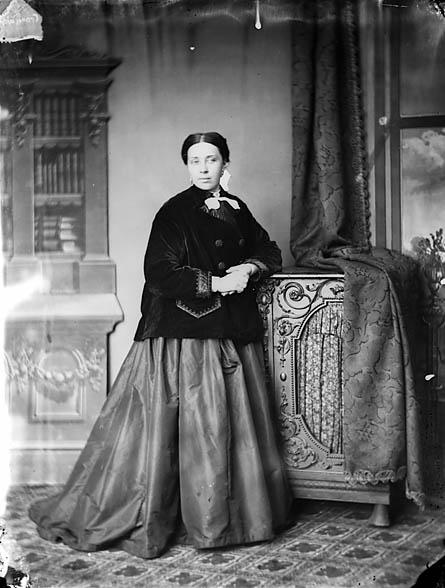 Black and white photo of Sarah Jane Rees in Victorian dress